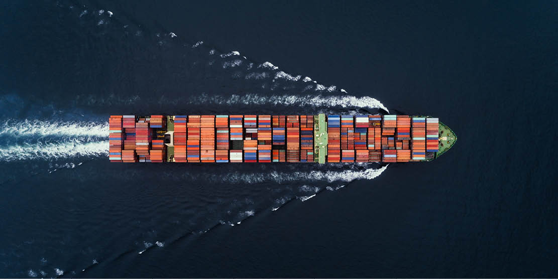 Container ship sails across ocean